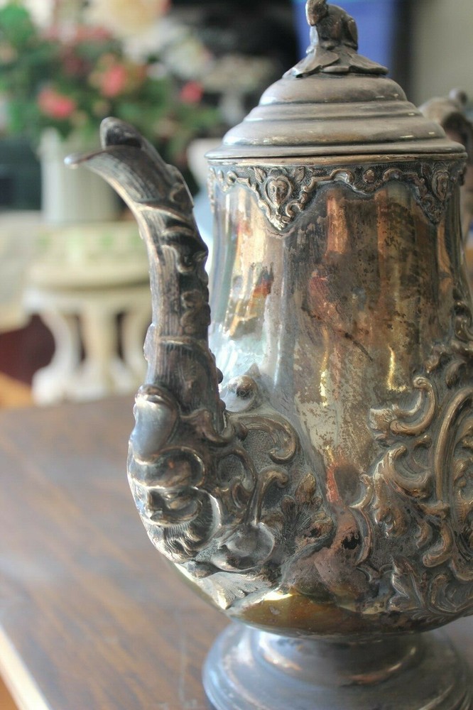 Silver or Silver-plate coffee pot with many animals embossed. July 8th 1856