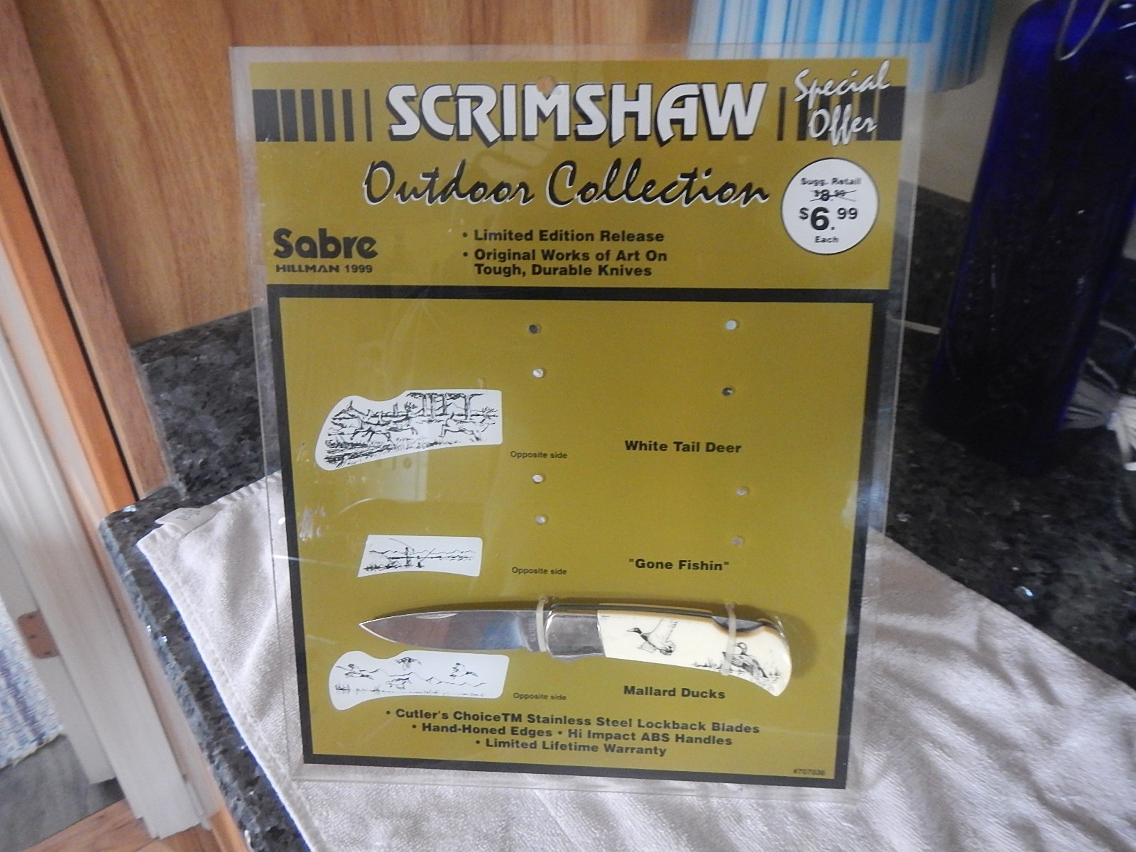 Vintage Sabre scrimshaw knife counter top store display with one NOS knife