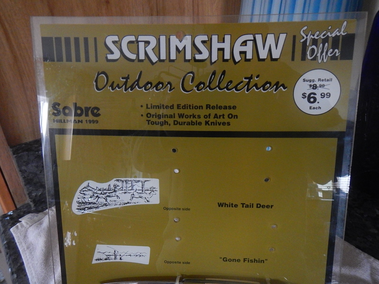 Vintage Sabre scrimshaw knife counter top store display with one NOS knife