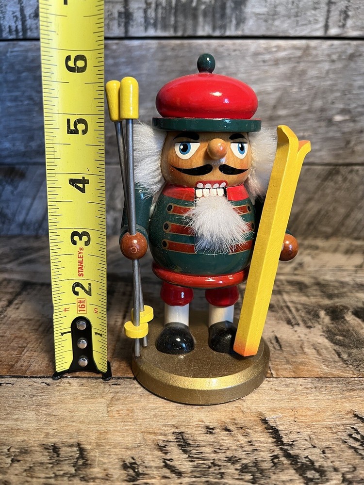Vintage Christmas Nutcracker Holding Skies