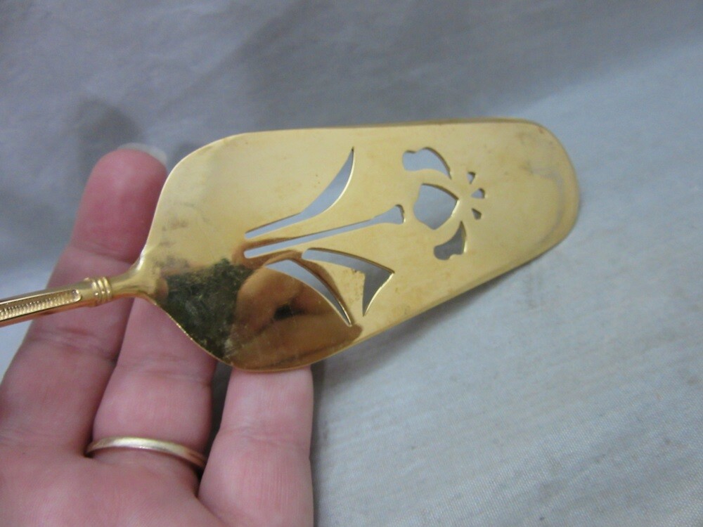 Gold plated cake server with red enamel handle