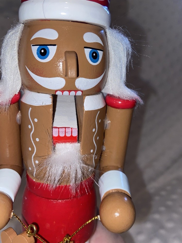 Wood Nutcracker With A String Of Gingerbread Men.
