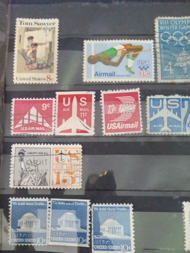 2" 3 ring binder w/ 5 pages of stamps over 100 usable stamps mostly US