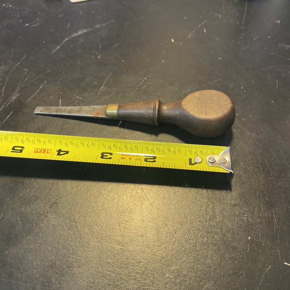 Wood handled screwdriver style tool with brass sparrow