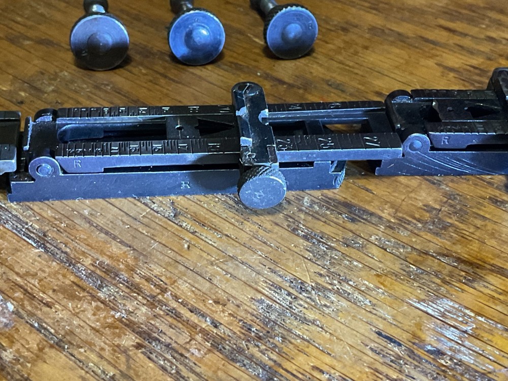 Remington 1903 sight base, leaf, slide, elevation, windage knobs marked R. 1 set