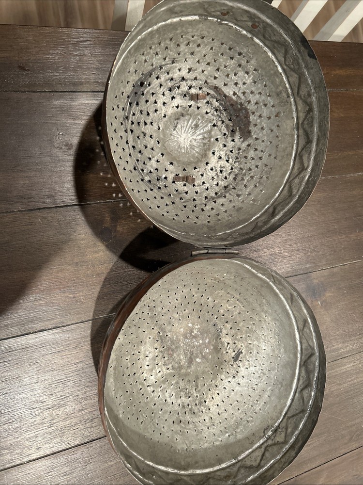 Antique Middle Eastern copper lidded storage container with geometric patterns.