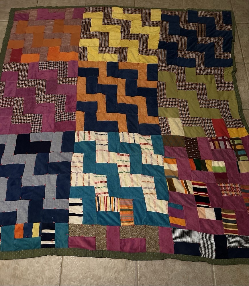Handmade patchwork quilt with geometric 'L' block pattern.
