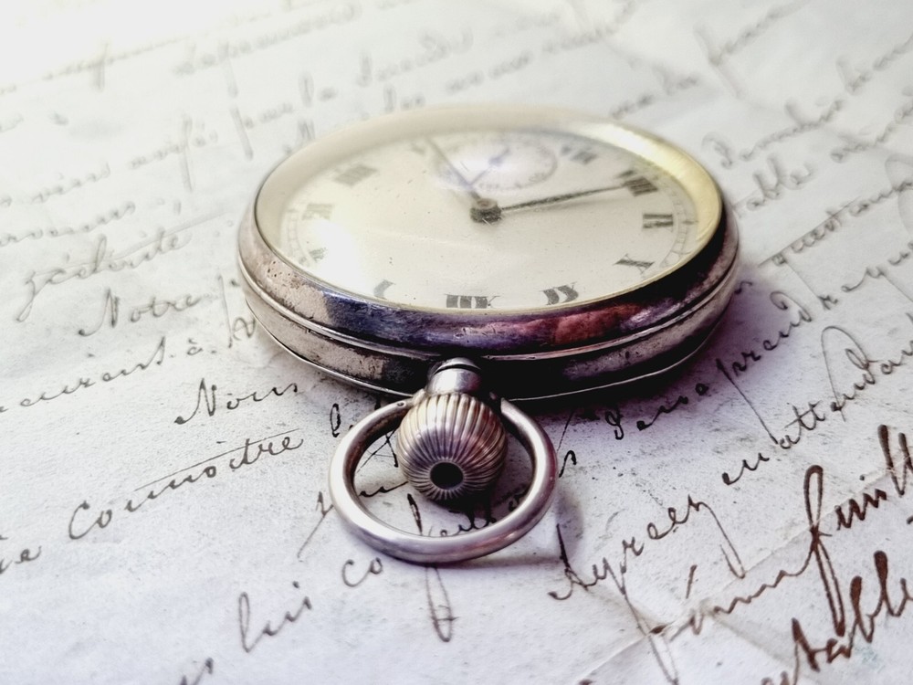 silver open face pocket watch