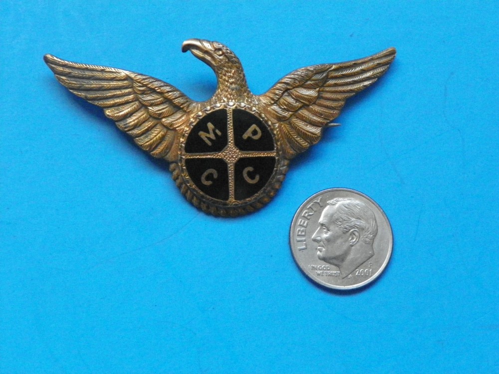 WWI ORIGINAL ODD HAND ENGRAVED 2 3/16" EARLY EAGLE WING MARKED "MPCC"