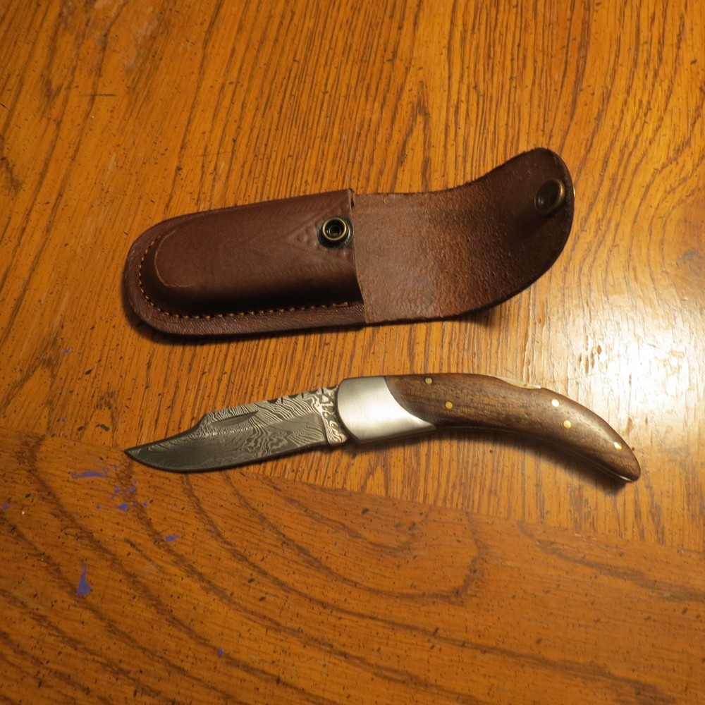 Damascus folding blade workers knife with dark wood handle hand made with sheath