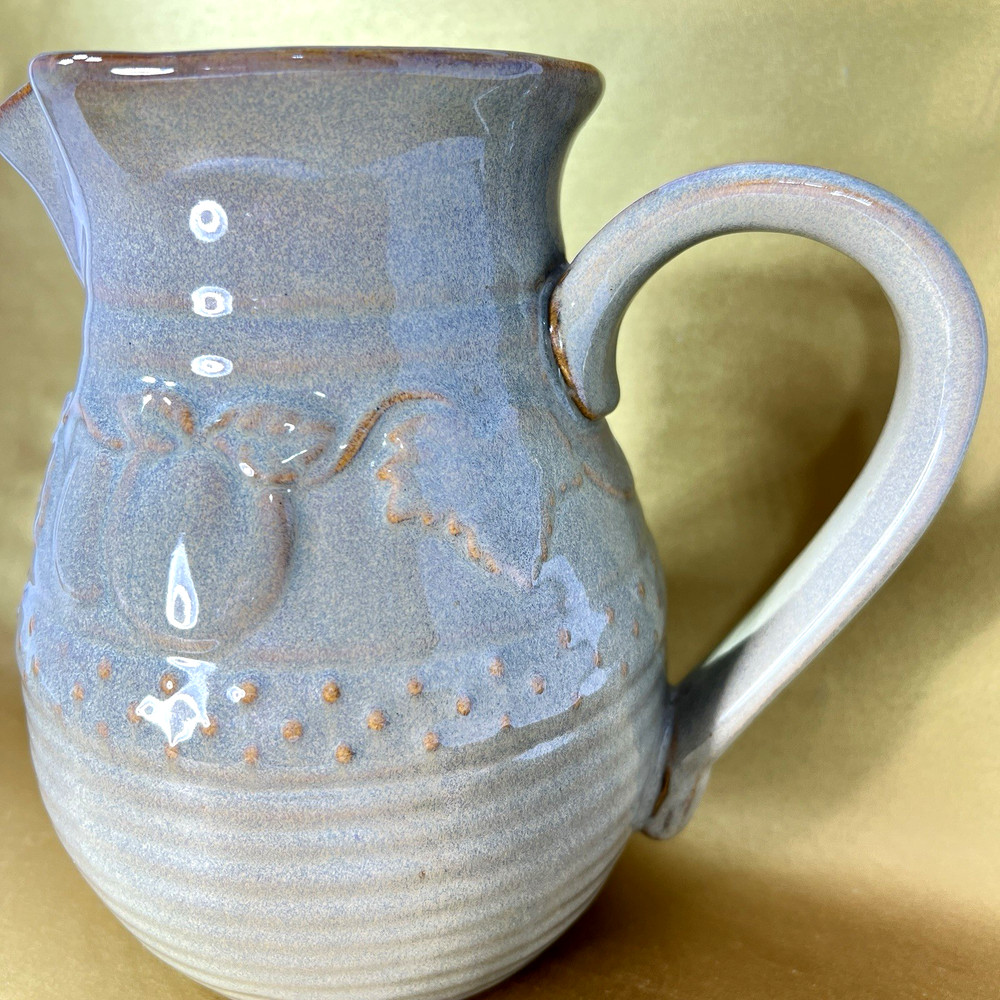 Unbranded Glazed Stoneware Pitcher embossed with fruit and glazed inside