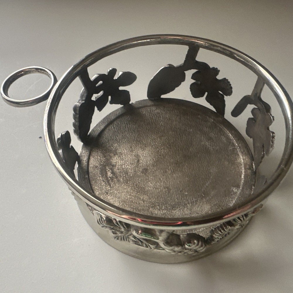 vintage, silver-plated wine bottle coaster featuring intricate grapevine pattern