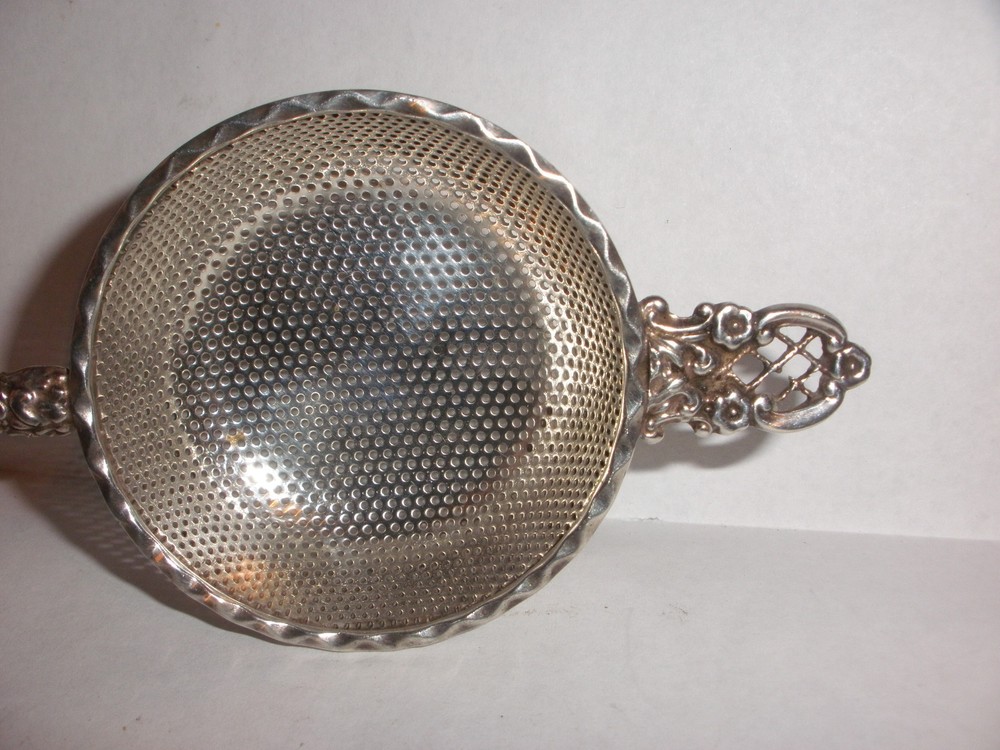 Nice Antique Continental silver flowers repousse tea strainer