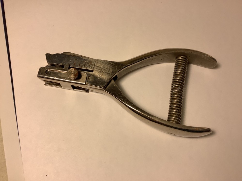 A.F. & Co. hole punch with spring handle action and adjustable punch depth guide