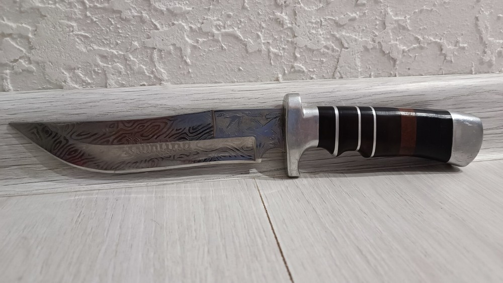 Antique handmade hunting knife with a pattern.