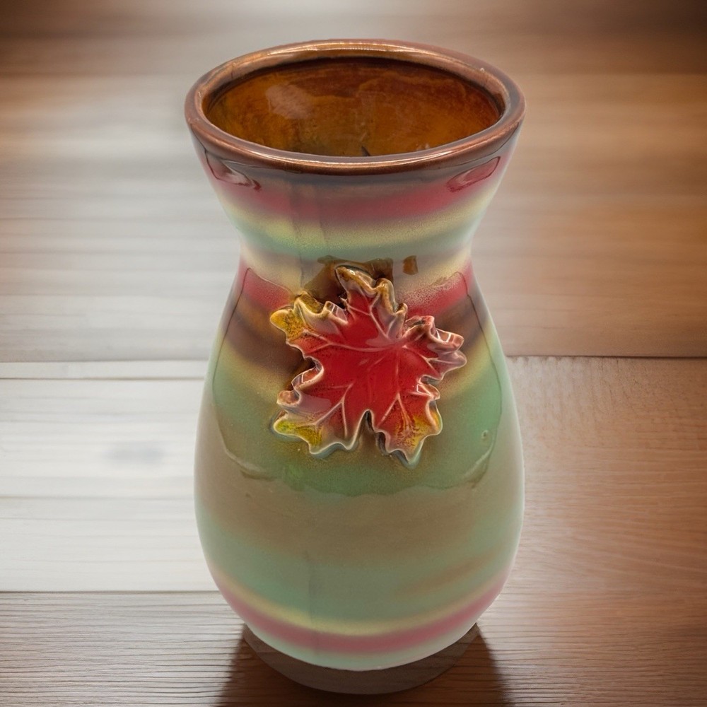 Stunning/9”/ceramic vase with a maple leaf design and a metallic glaze.