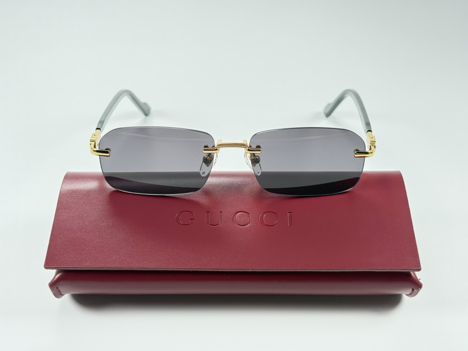 Gucci GG1221S 001 Black Gold Rimless Sunglasses Gray Lens 56mm