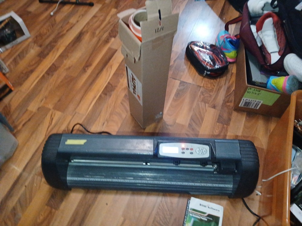 computer-controlled vinyl cutter machine Some Vinyl Material And Two Discs