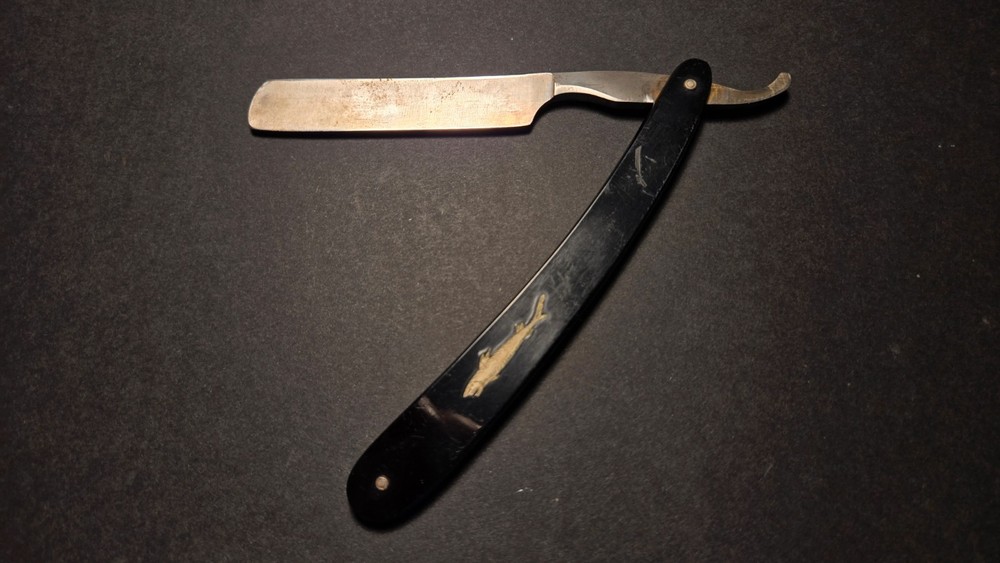Vintage, old antique Straight Razor with fish