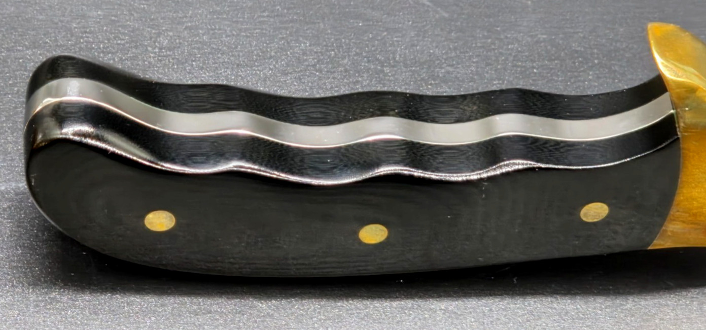 Buck Kalinga knife with black handle and brown leather sheath