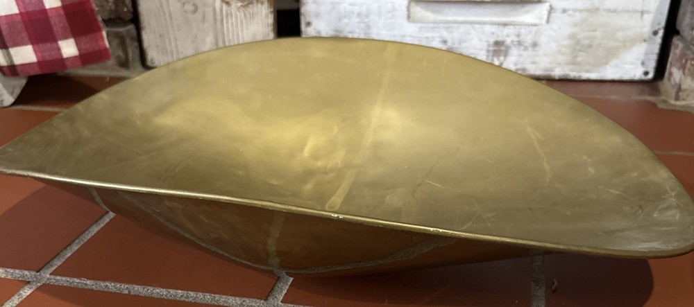 A large, antique solid brass mercantile scale pan.