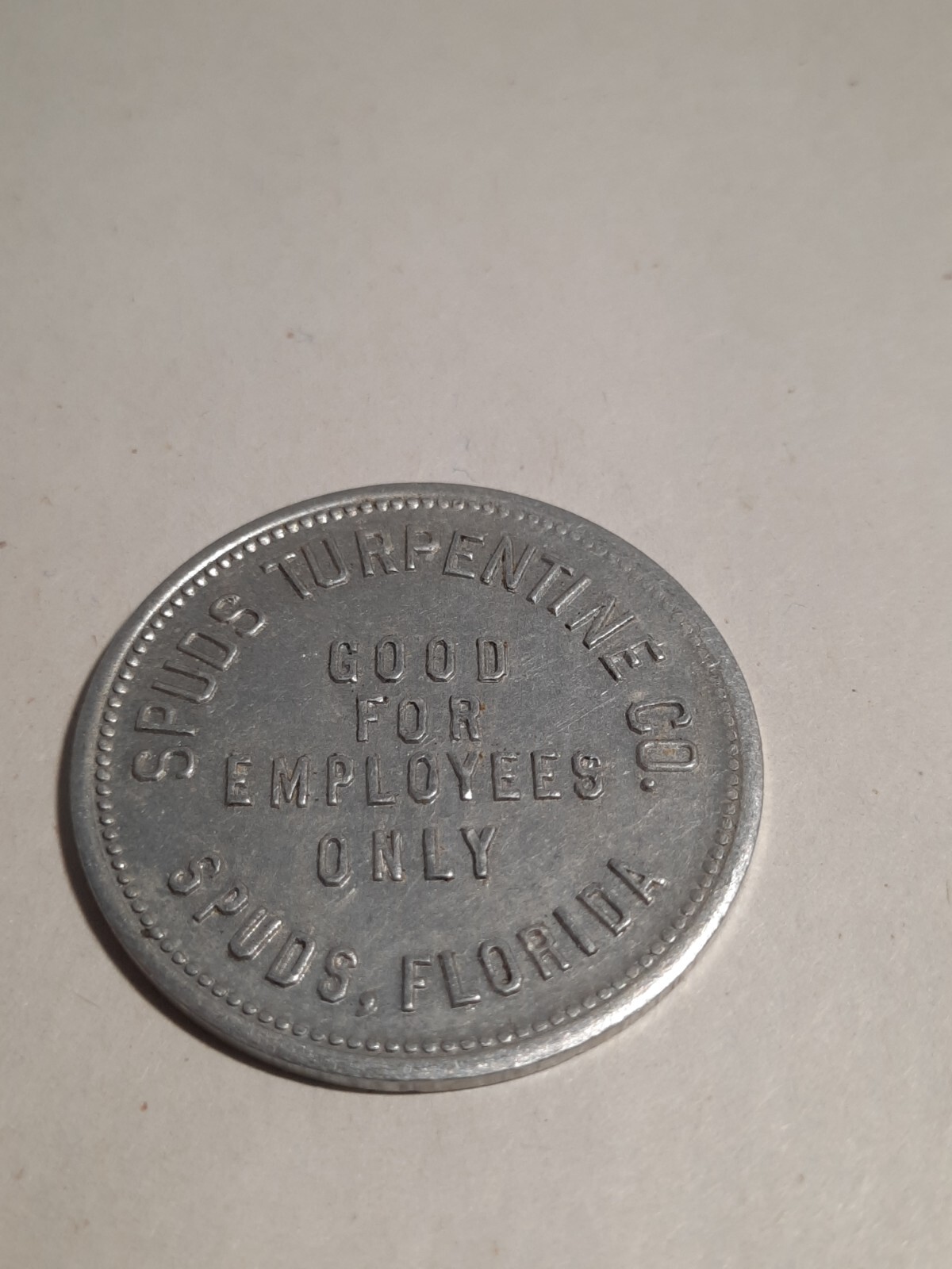 $1.00 Token: Spuds Turpentine Company, Spuds, Florida, 35mm Aluminum