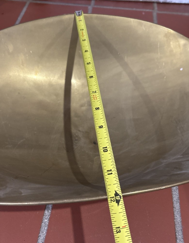 A large, antique solid brass mercantile scale pan.