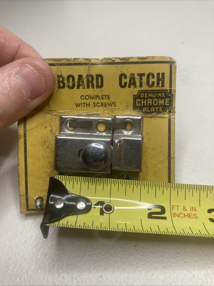 NOS- vintage chrome-plated cupboard catch.