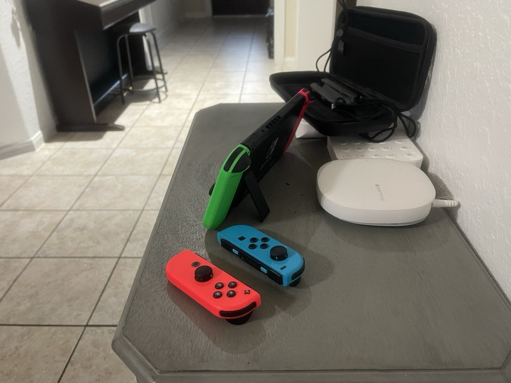 Nintendo Switch Including The Case, And Four Joy controllers.