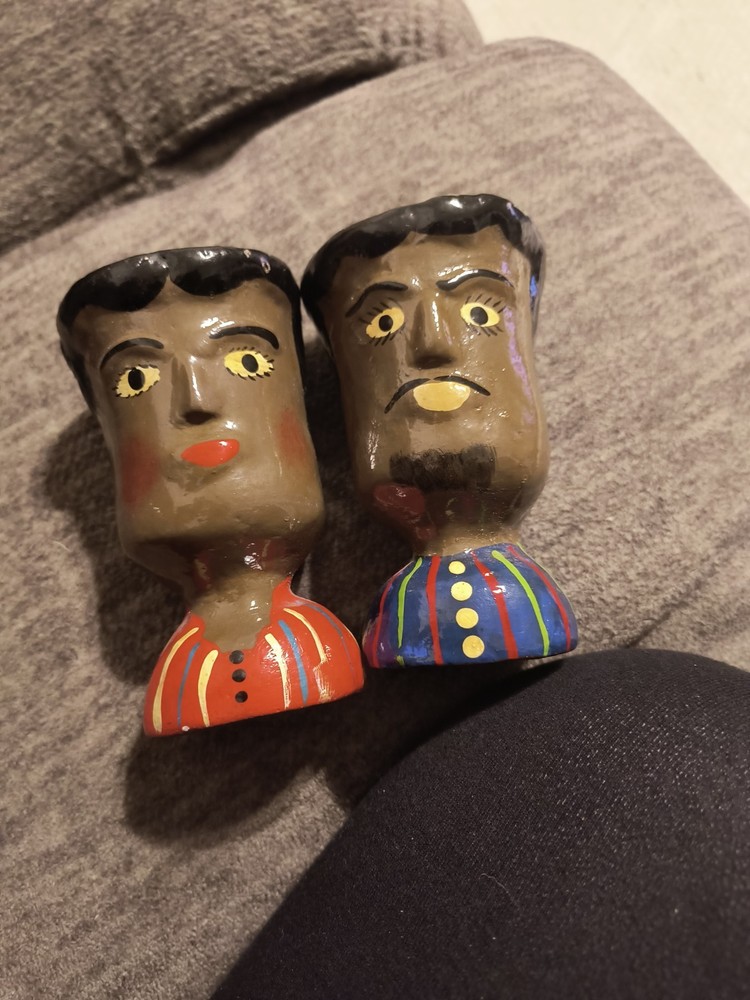 These items are handcrafted ceramic face vases or pots