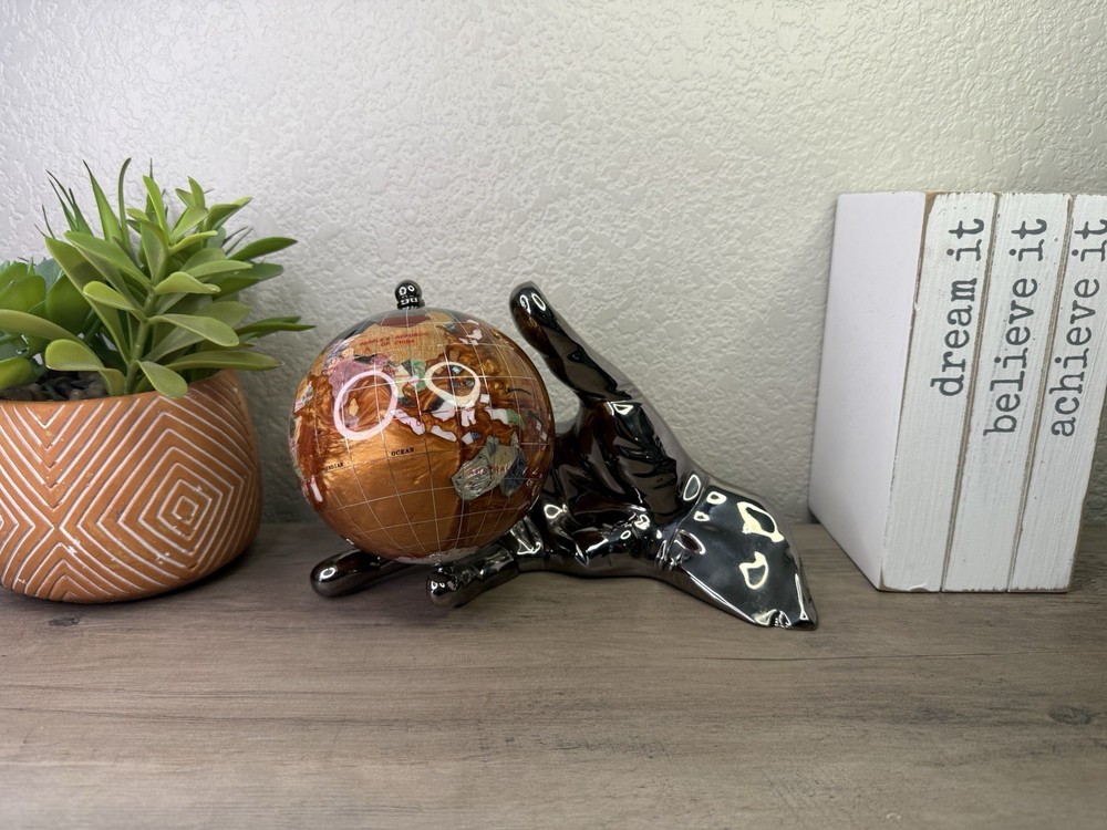 hand holding gemstone globe decor