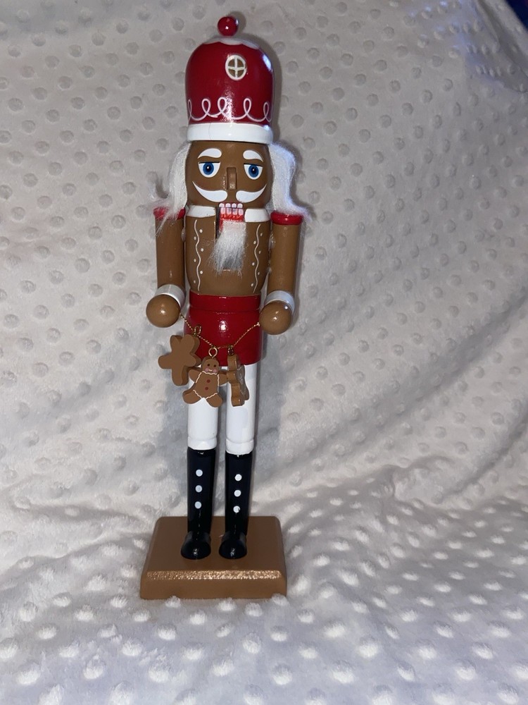 Wood Nutcracker With A String Of Gingerbread Men.